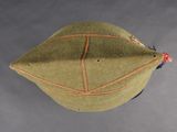 a close up of a green hat with orange stitching