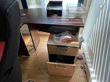 a desk with a computer on top of it in a room
