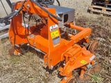 an image of a small orange machine in a yard