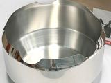 a large metal bowl sitting on a table next to a box
