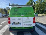 a green and white van parked on the side of the road