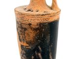 a vase that is sitting on a stand on a white surface
