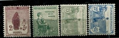 four different colored stamps on a black surface with a black background