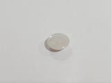 a close up of a white button on a white surface