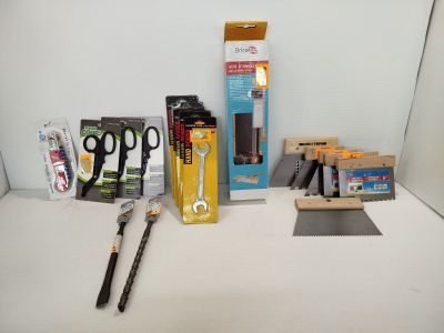 a box of scissors, a pair of scissors, and a pair of scissors on a table
