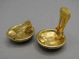 two gold plated spoons with a spoon in the middle of them