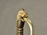 a close up of a gold colored cane with a lion head on it