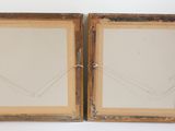 pair of antique wooden picture frames with rope hanging from them