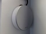 a white light that is on the wall above a toilet