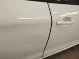 a white car with a black door handle on the side of the car