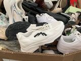 many pairs of shoes in a box on the floor