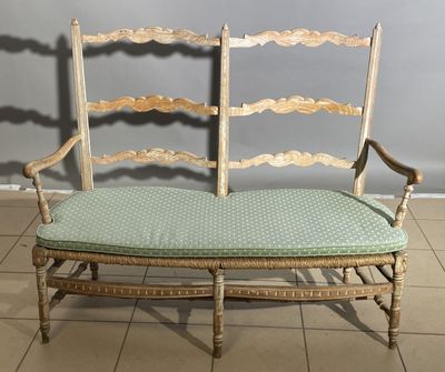 a wooden bench with a green cushion on top of it