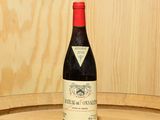 une bouteille de vin posée sur un tonneau en bois