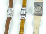 trois types de montres sont présentés sur une surface blanche
