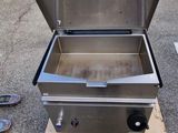 a grill that is sitting on a pallet on the ground
