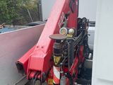 a red crane that is sitting on the back of a truck