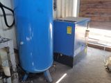 a blue tank sitting next to a blue machine in a room