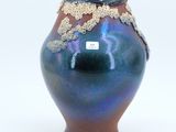 a blue vase with a brown and blue design on it