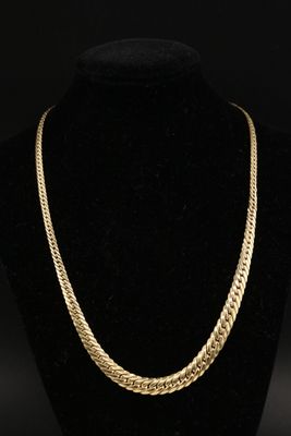 un collier à chaîne en or sur un mannequin noir