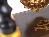 a gold seal sitting on top of a book on a table