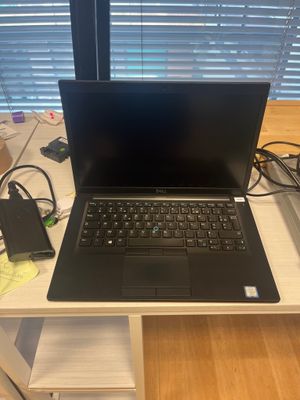 a laptop computer sitting on top of a white desk