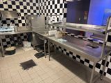 a kitchen with a checkered wall and stainless steel counter tops