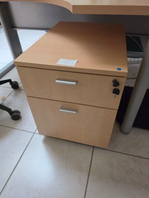 a desk with a file cabinet and a computer monitor on it