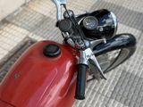 a red motorcycle parked on the side of the street