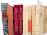 many books that are stacked on top of each other