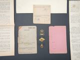 some old papers and other items sitting on a table next to each other