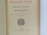 an open book with a picture of a coat of arms and a coat of arms on top of it