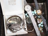 a box with a bunch of jewelry inside of it