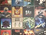 many different album covers on the wall of a room