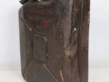 an old metal jerry can sitting on top of a white table
