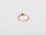 a close up of a gold ring on a white surface
