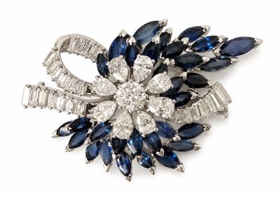 an image of a brooch with blue and white stones