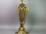 a gold vase that is sitting on a table