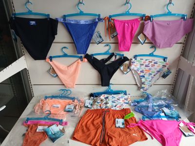 a lot of underwear hanging on a wall in a store