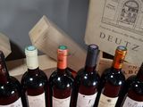 several bottles of wine are lined up in a row on a table