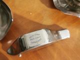 a spoon and spoon rest on a table next to a cup and saucer