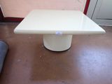 a white table on the floor in front of a door