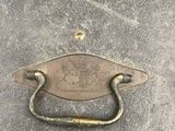 a close up of a metal handle on an old suitcase