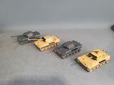 several toy tanks are lined up in a row on a table