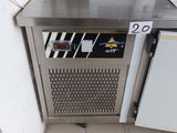 a stainless steel counter with a freezer on it