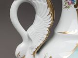 a vase that has a swan on the side of it
