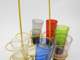 many different colored glasses in a metal holder