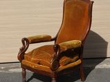 a brown chair that is sitting in the street
