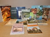 several books are sitting on a table in front of a wall