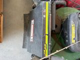 a lawn mower that is sitting in the garage
