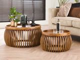 two tables that are sitting on the floor in the living room